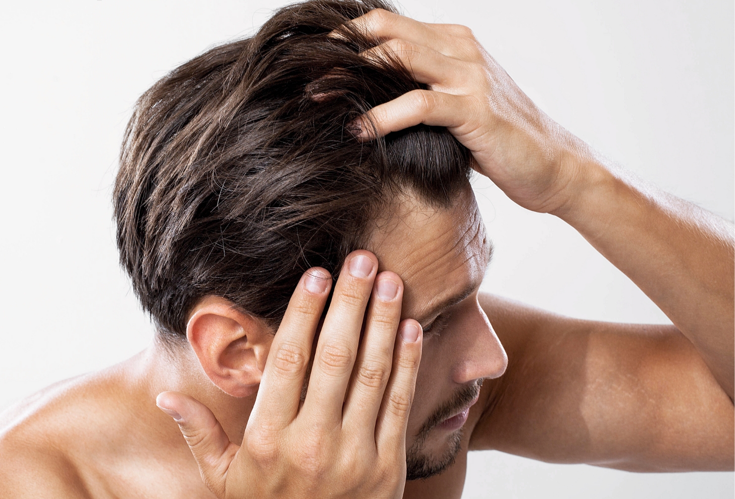 Man massaging scalp. cosmetic hair care and scalp stimulation
